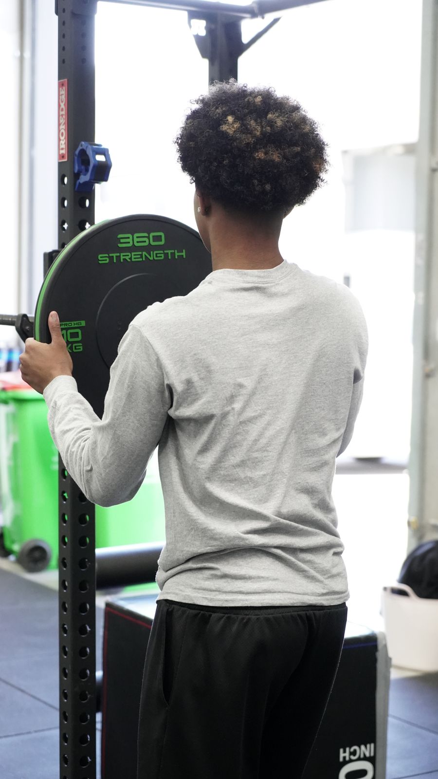 Athlete loading plates in the gym