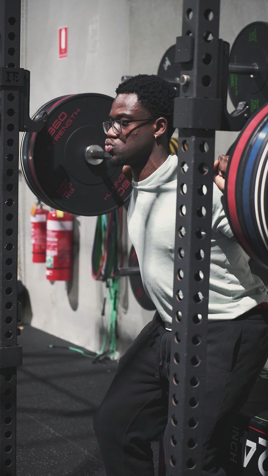 Athlete under the bar in the squat rack